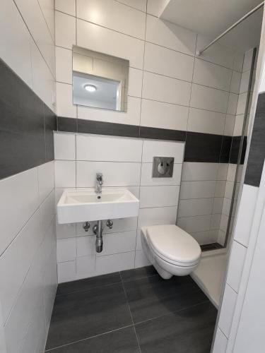 a bathroom with a toilet and a sink at Baden-Baden Zentrum Studio in Baden-Baden