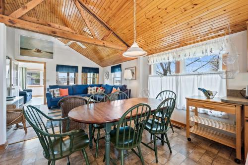 a dining room and living room with a table and chairs at Les Bon Temps in Birch Town
