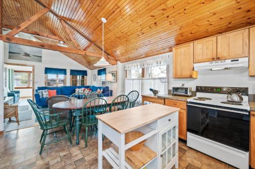 a kitchen and living room with a table and chairs at Les Bon Temps in Birch Town