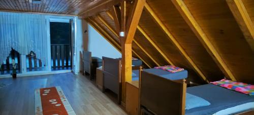 a room with two beds and a balcony at Villa sul lago in Jajce