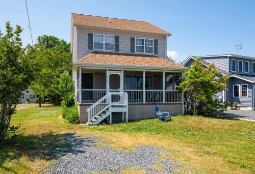 a house with a front porch and a yard at Lighthouse Overlook in Birch Town