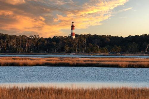 a lighthouse in the middle of a body of water at Lighthouse Pointe in Birch Town