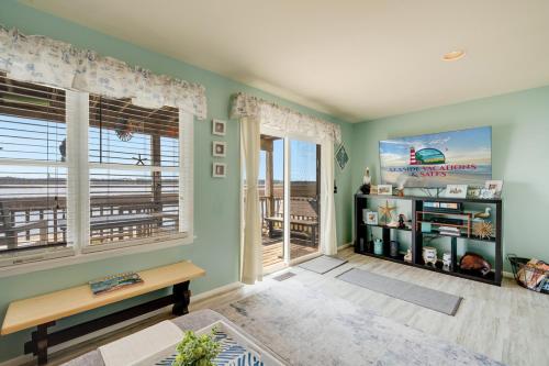 a living room with green walls and large windows at Lighthouse Pointe in Birch Town