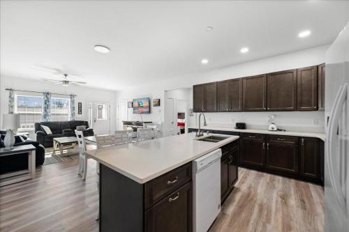 a kitchen with wooden cabinets and a living room at Lily Pad 2 in Birch Town