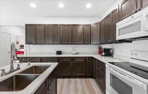 a kitchen with wooden cabinets and stainless steel appliances at Lily Pad 2 in Birch Town