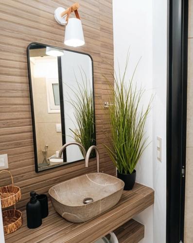 a bathroom with a sink and a mirror at Lux Studios With Private Pool by ILIOS Georgioupoli in Georgioupoli