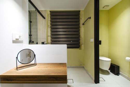a bathroom with a mirror and a toilet at Archontiki Elite Villa - Private Pool, Chania in Vryses