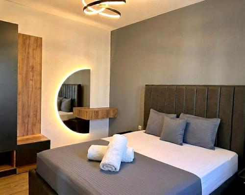 a bedroom with a large bed with towels on it at SUPREME Luxury in Ulcinj
