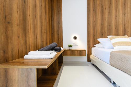 a bedroom with a bed and a wooden wall at Archontiki Elite Villa - Private Pool, Chania in Vryses