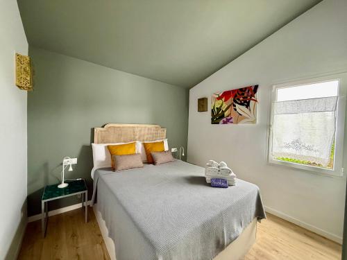 a bedroom with a bed and a window at Xalet Son Favaritx by GMHouse Menorca in Cala en Bosc