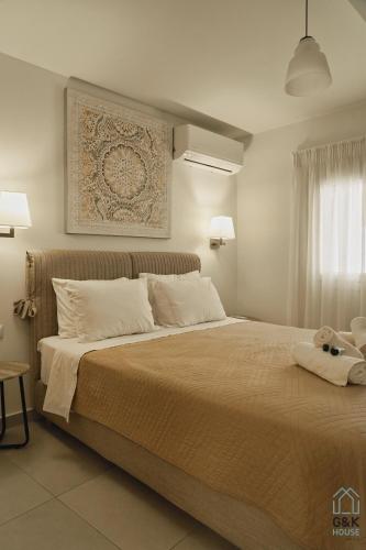 a bedroom with a large bed with two towels on it at G&K House Garden in Messini