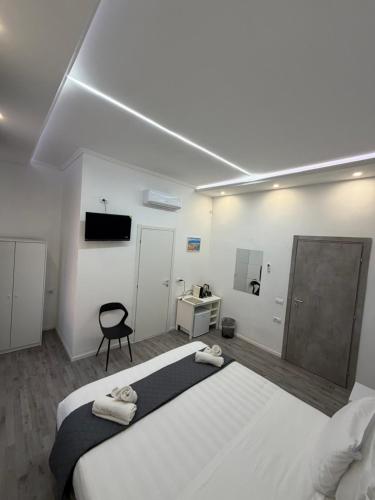 a bedroom with a large bed with two towels on it at Residenza Delle Isole in Piombino