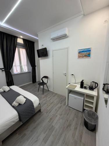 a hotel room with a bed and a desk at Residenza Delle Isole in Piombino