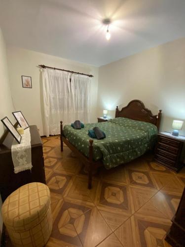 a bedroom with a bed and a chair in it at Meira House in Belinho