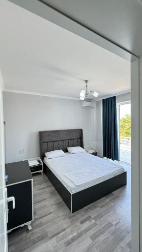 a bedroom with a large bed and a large window at Astara Villa Kiraye in Astara