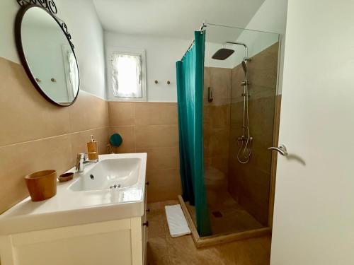 a bathroom with a sink and a shower with a mirror at Xalet Son Favaritx by GMHouse Menorca in Cala en Bosc
