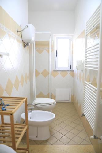 a bathroom with a toilet and a sink at House Mimma Tropea in Santa Domenica