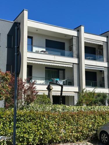 a man is playing basketball in front of a building at White Sand Apartment Valamar 2 Bedroom Balcony Parking in Draç