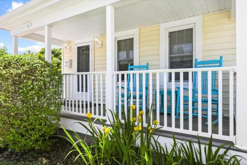 a house with a white fence and a swimming pool at Precious Time in Chincoteague