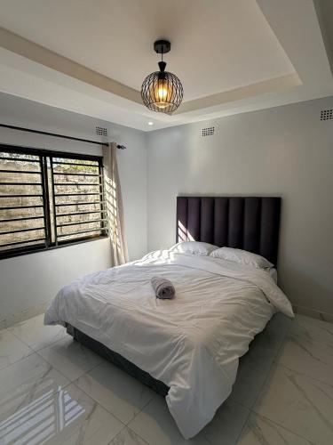 a bedroom with a large bed in a room at Central place in Lusaka