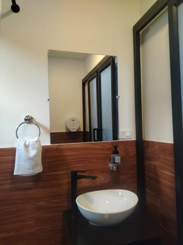 a bathroom with a sink and a mirror at Tungurahua Eco Lodge INN BAÑOS in Quillullaco