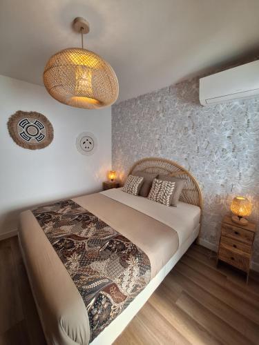 a bedroom with a large bed and a chandelier at Villa Pesona in Vias