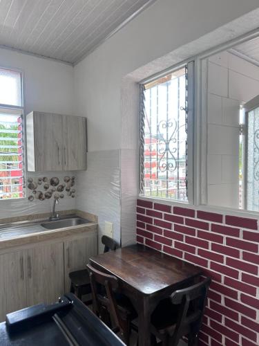 a kitchen with a table and a pool table at Hotel San Luis in Buga