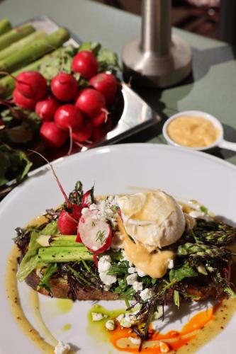 a plate of food with vegetables on a table at InPoint Apartments G15 near Old Town & Kazimierz District & Optional Paid Parking in Krakow
