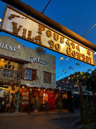 a restaurant with a sign that reads rooster and dog soup at Pousada Vila do Cowboy in Penha