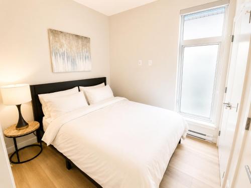 a bedroom with a white bed and a window at Lovely Brand New Suite in Sidney