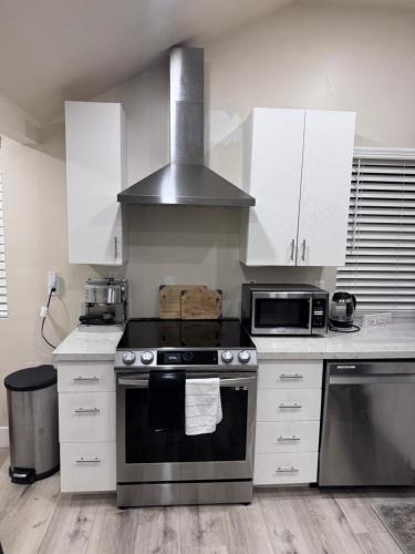 a kitchen with a stove and a microwave at Private Studio, Near DT & Cal Expo, Free Parking in Sacramento