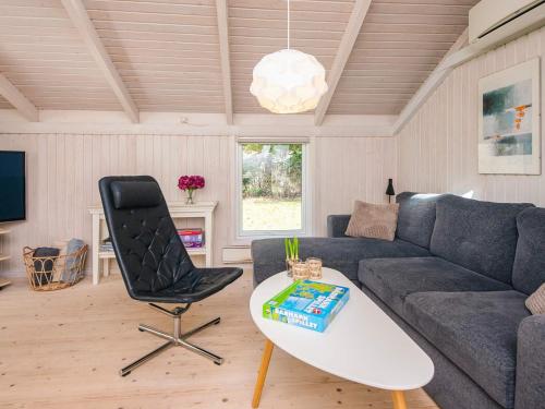 a living room with a couch and a chair at 6 person holiday home in Ulfborg in Ulfborg