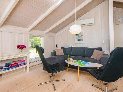 a living room with a couch and a table at 6 person holiday home in Ulfborg in Ulfborg