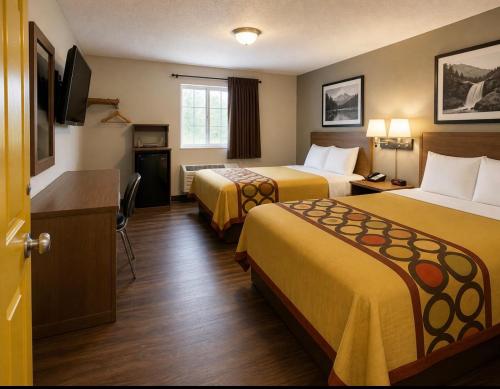 a hotel room with two beds and a flat screen tv at Westgate Manor Motel Austintown & Youngstown OHIO in Youngstown