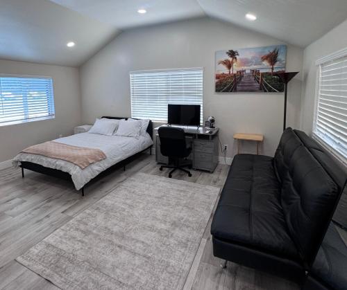a bedroom with a bed and a desk with a computer at Private Studio, Near DT & Cal Expo, Free Parking in Sacramento