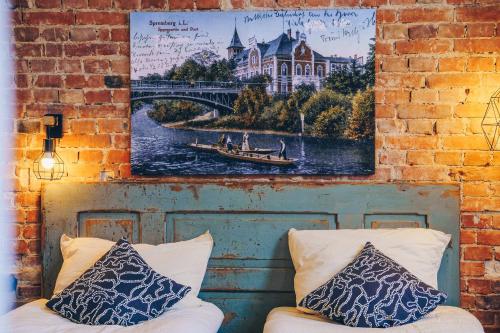 a painting of a bridge and a boat on a river at Old Post Loft Apartments in Spremberg