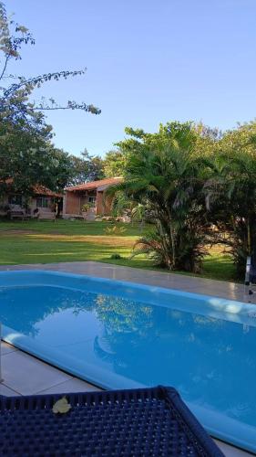 a large blue swimming pool in front of a house at Pousada Floradas da Serra in Chapada dos Guimarães