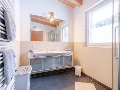 a bathroom with a sink and a window at Saalbach Hinterglemm in Viehhofen
