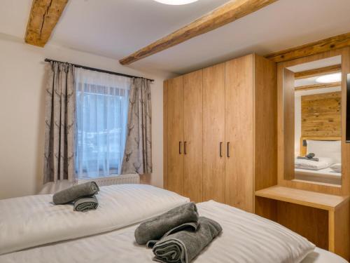 a bedroom with two beds and a mirror at Chalet Bergglück in Sellrain