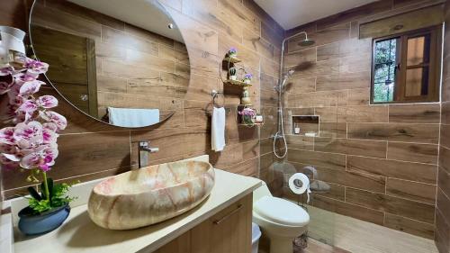 a bathroom with a sink and a mirror at Villa Ana Rosa in Jarabacoa