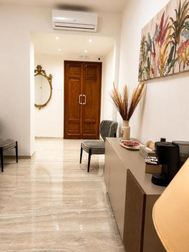 a lobby with a reception desk and a door at Valentina Rooms in Bronte