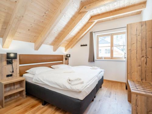 a bedroom with a large bed and a window at Haus am Bach in Donnersbachwald