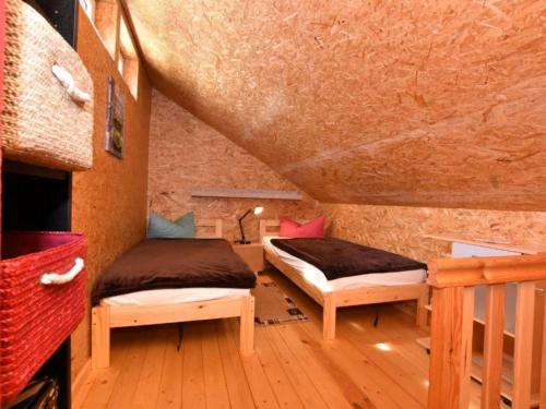two beds sitting in a room with a staircase at Am Triensee in Rühn