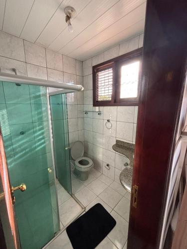 a bathroom with a glass shower and a toilet at Espaço Cultural Morada in São Luís