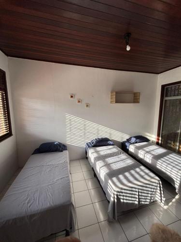 a bedroom with two beds and a window at Espaço Cultural Morada in São Luís