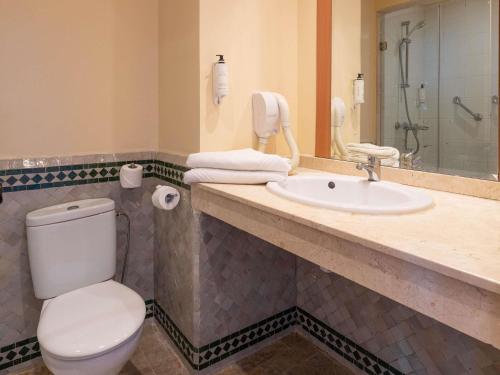 a bathroom with a toilet and a sink at Ibis Fes in Fez