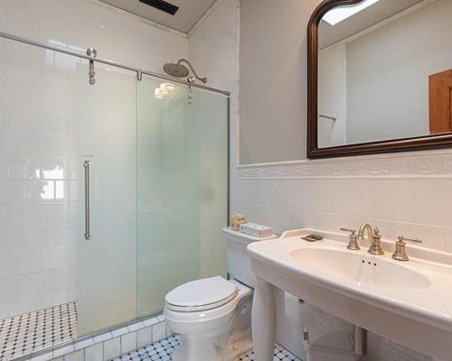 a bathroom with a shower and a toilet and a sink at The Kleemann House-1883 Historic Downtown Hotel in Custer