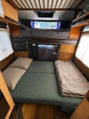a small bed in the back of an rv at Charmantes Oldtimer Wohnmobil in Aachen