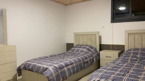 a bedroom with two beds at Sadeel chalet in Kerak