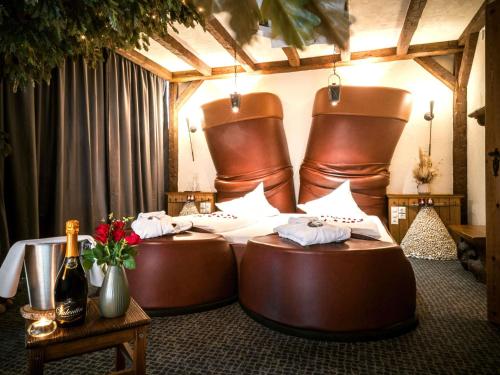 a hotel room with two large beds with towels at Mercure Hotel Riesa Dresden Elbland in Riesa
